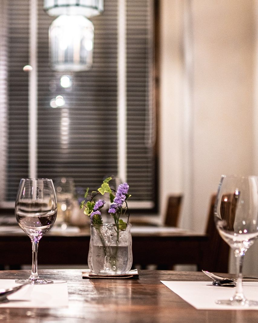 Wine glasses on a table at night